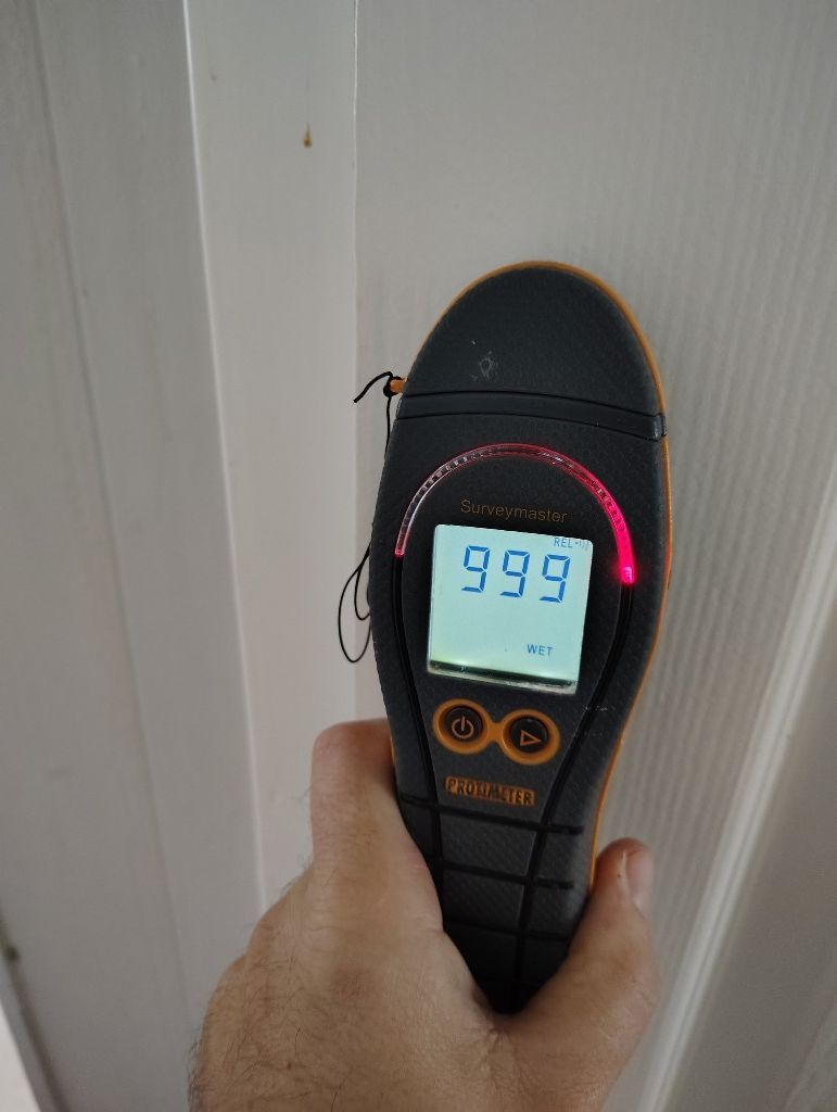 A person is holding a device that says 999 on the screen.