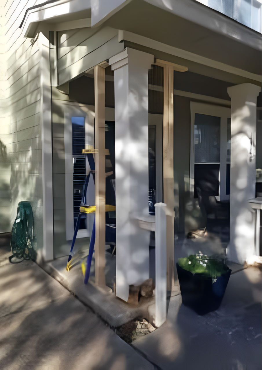 A ladder is sitting on the sidewalk in front of a house under construction.