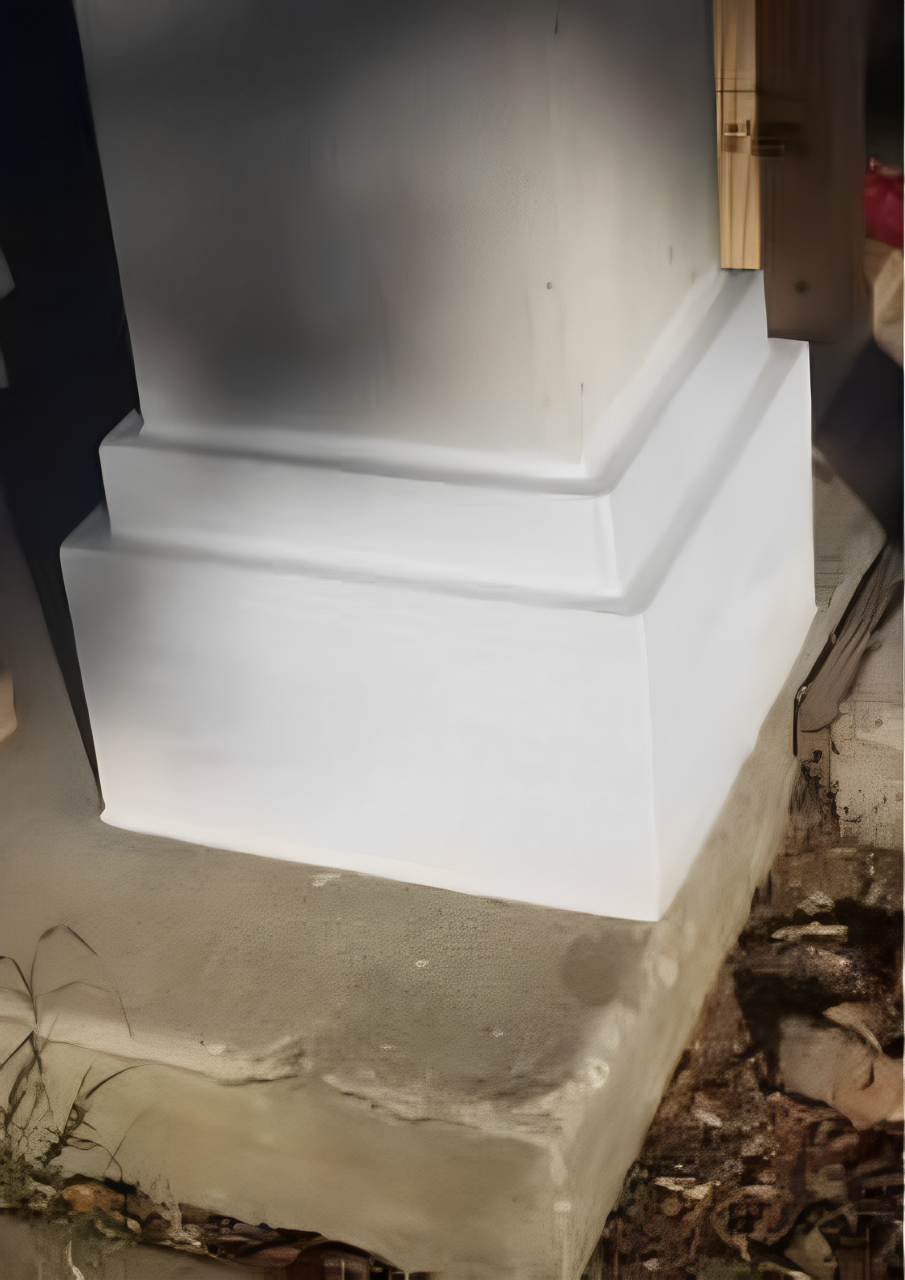 A white column is sitting on top of a concrete base.