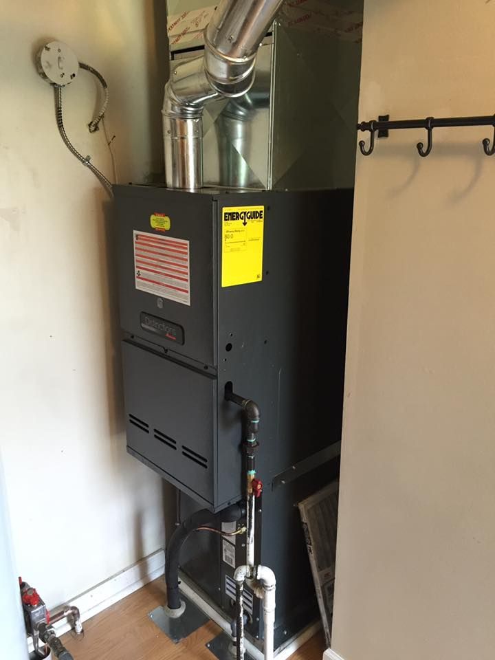Black furnace with metal venting in a narrow utility room