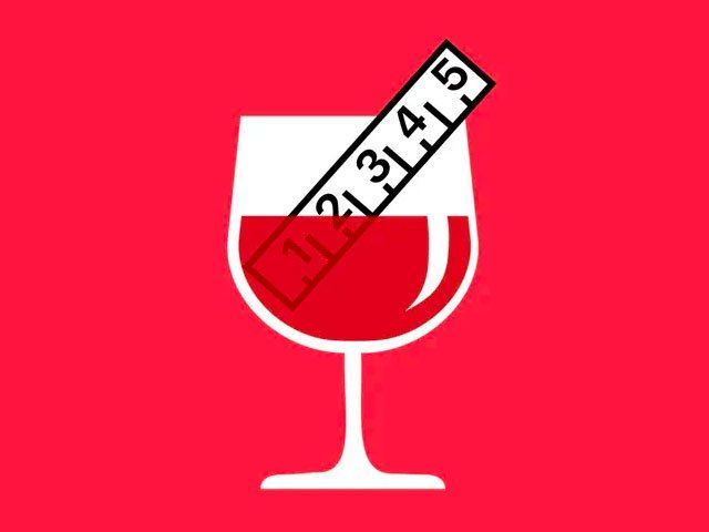 A measuring tape is sticking out of a glass of wine