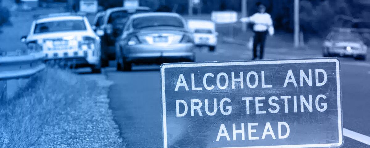 A sign on the side of the road says
