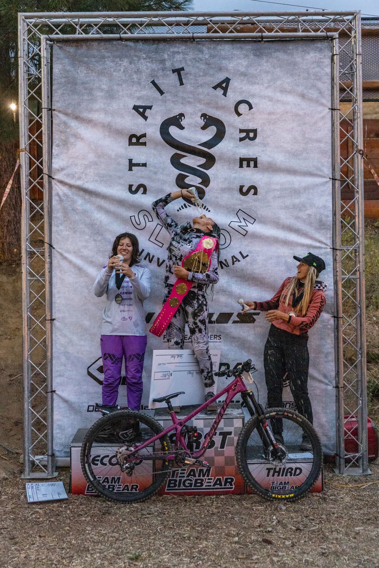 Mountain bike race winners on a podium. 