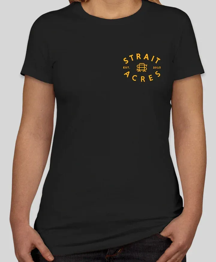 Woman wearing a black t-shirt with a gold