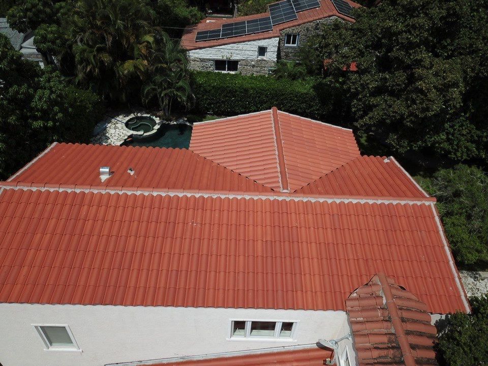 An aerial view of a house with a red tiled roof