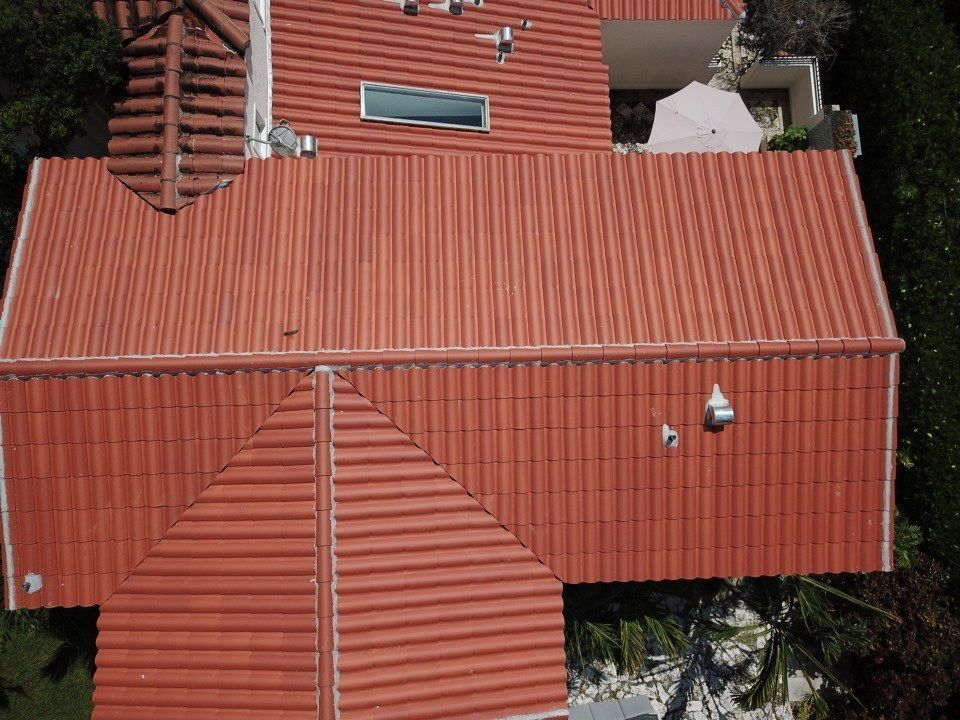 An aerial view of a house with a red tiled roof