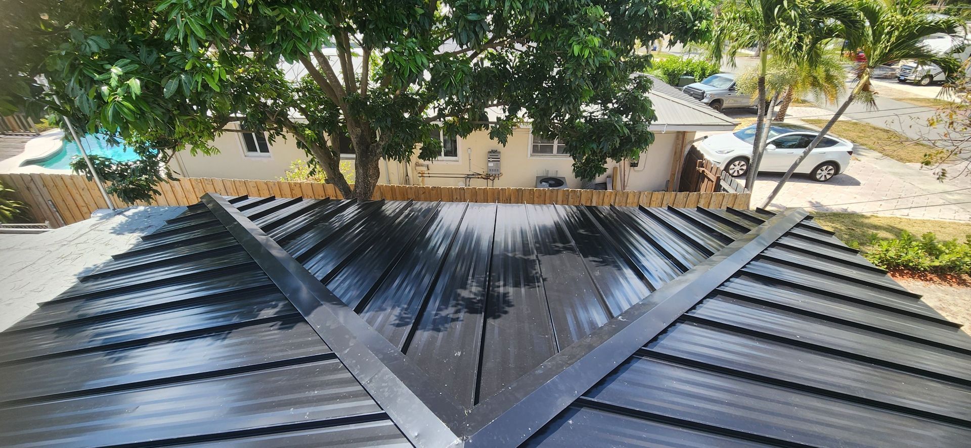 A black roof with a tree on top of it.
