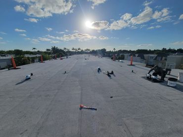 A group of people are working on a roof.
