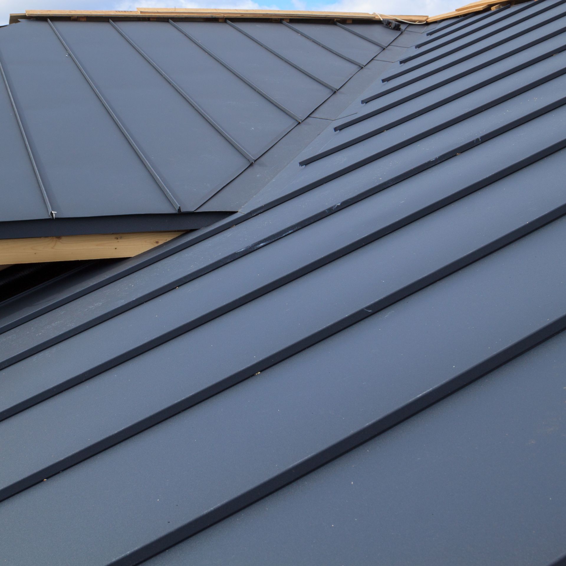 A close up of a gray metal roof on a house.