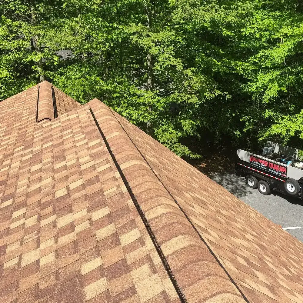 A truck is parked on the roof of a house.