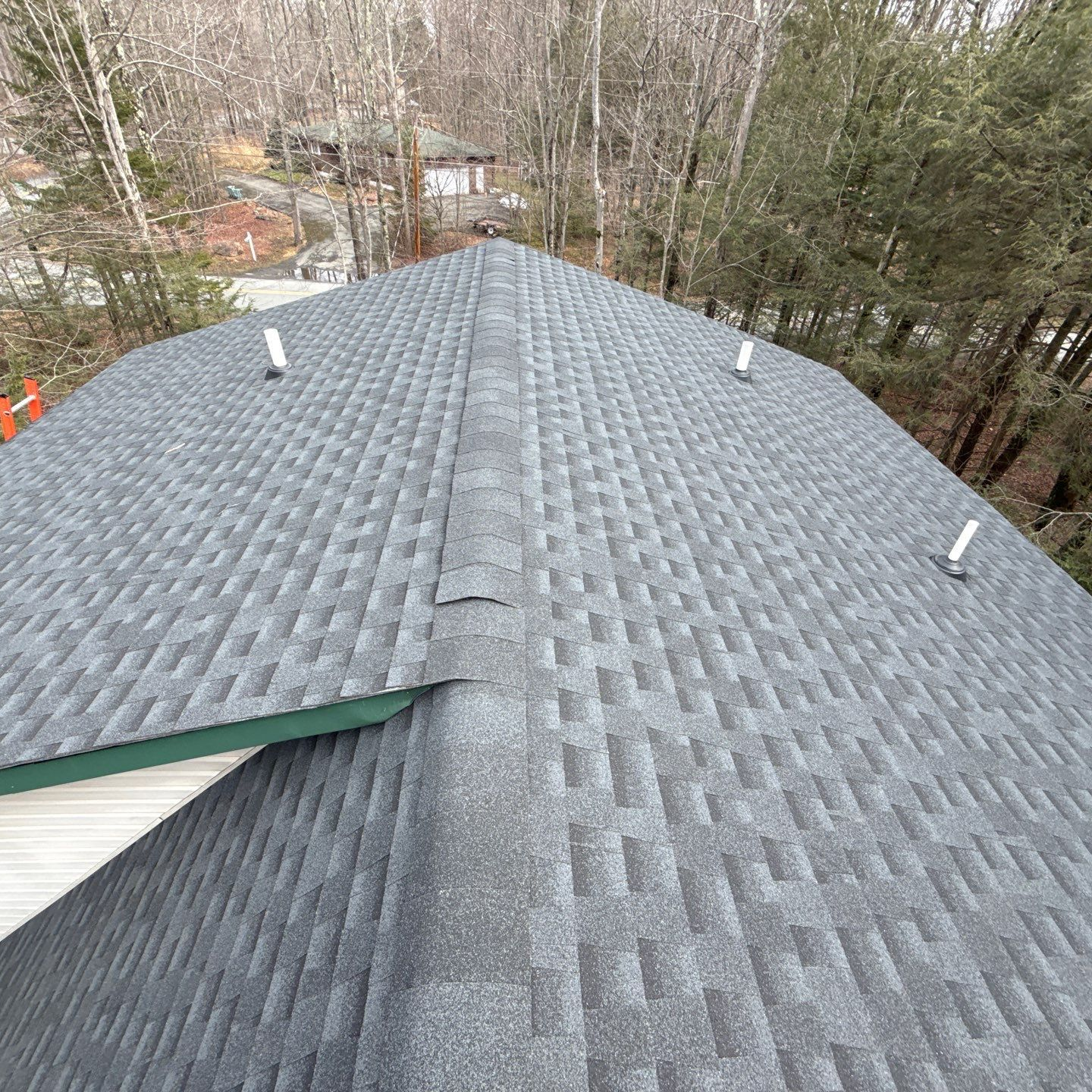 A close up of a roof with shingles and a gutter. A close up of a roof with shingles and a gutter.