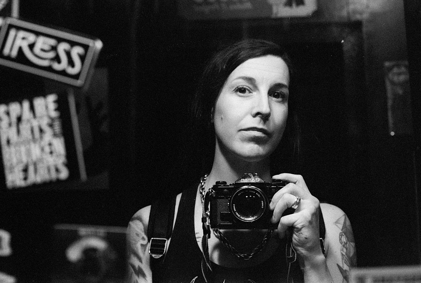 Black and white self portrait by photographer Madison Avery Somerville. The image was captured on a Canon A1 film camera. The film was developed and printed in a traditional wet darkroom by the photographer.