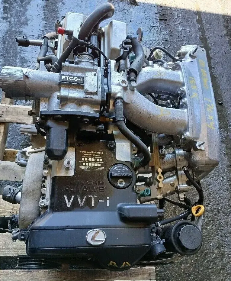 A lexus engine is sitting on top of a wooden pallet. A lexus engine is sitting on top of a wooden pallet.