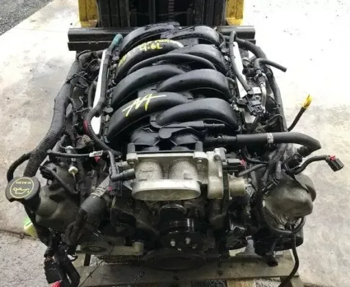 A ford engine is sitting on top of a wooden pallet. A ford engine is sitting on top of a wooden pallet.