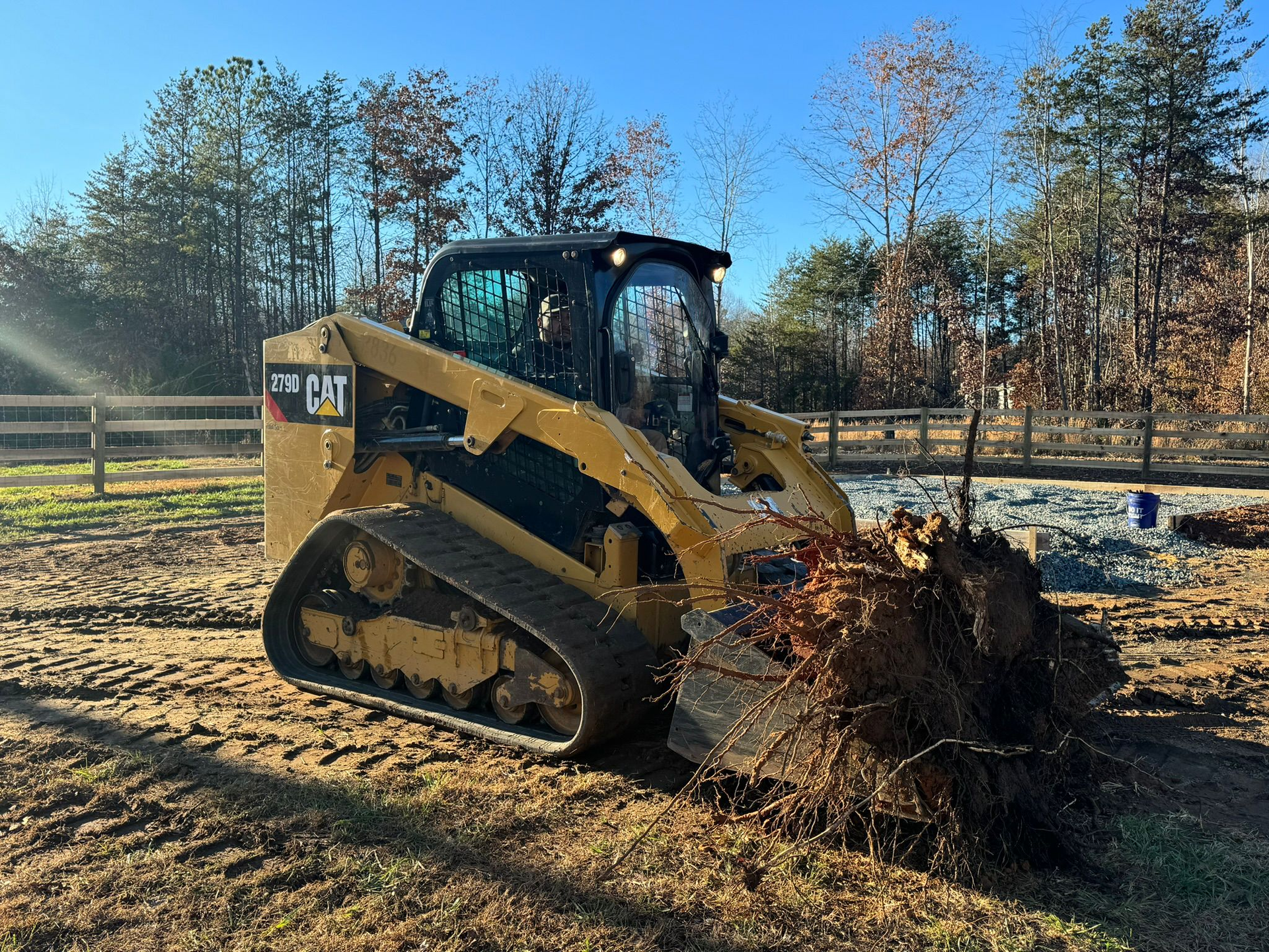 A bulldozer is digging a hole in the dirt in a field.