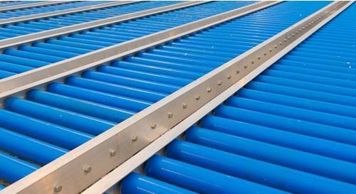 A close up of a conveyor belt with blue rollers on it.