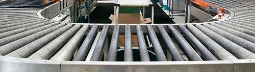 A conveyor belt with a box on it in a factory.
