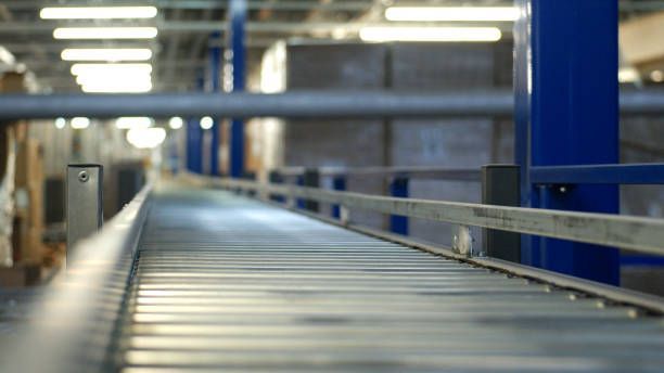 A conveyor belt in a warehouse with boxes on it.