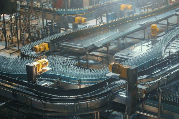 A conveyor belt filled with bottles in a factory.