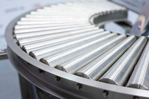 A close up of a conveyor belt with metal rods on it.