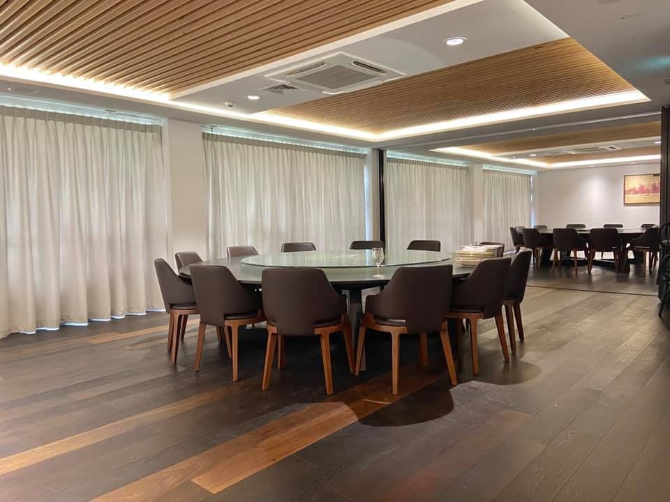 A Large Dining Room With a Round Table and Chairs — Whitsunday Vogue Interiors in Cannonvale, QLD