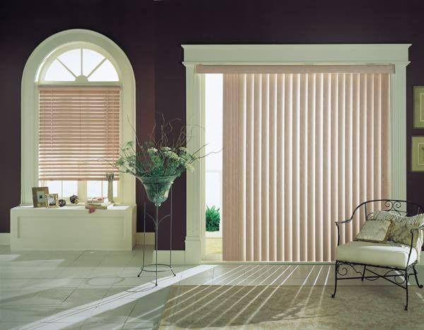 Interior With Arched Window With Blinds, Vertical Blinds on Sliding Door, Chair, and Plant Stand — Whitsunday Vogue Interiors in Cannonvale, QLD
