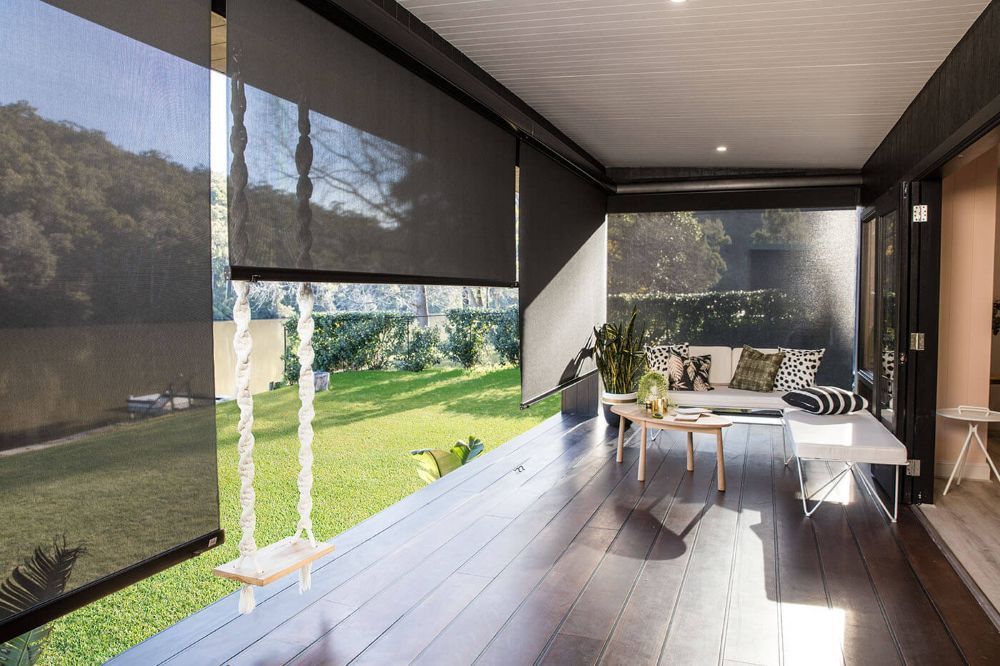 A Living Room With a Couch, Table, and Chairs on a Porch — Whitsunday Vogue Interiors in Cannonvale, QLD