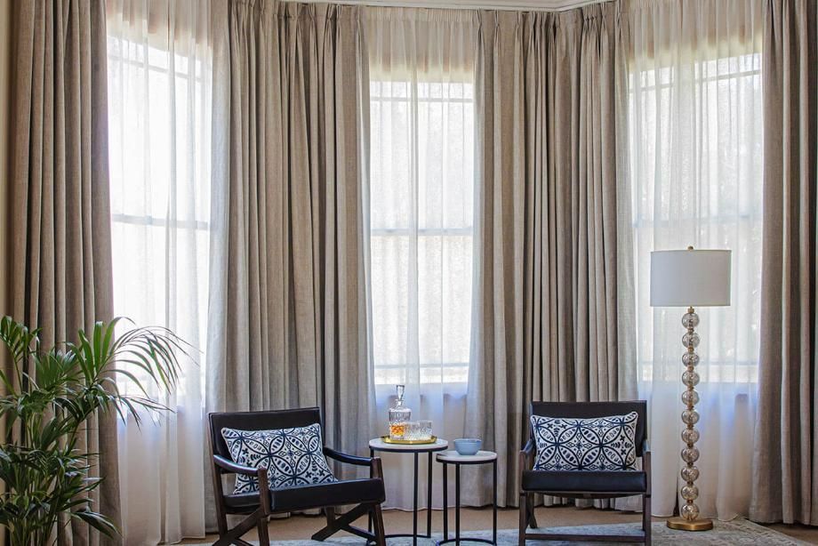 A Living Room With Two Chairs, a Table and a Lamp — Whitsunday Vogue Interiors in Cannonvale, QLD