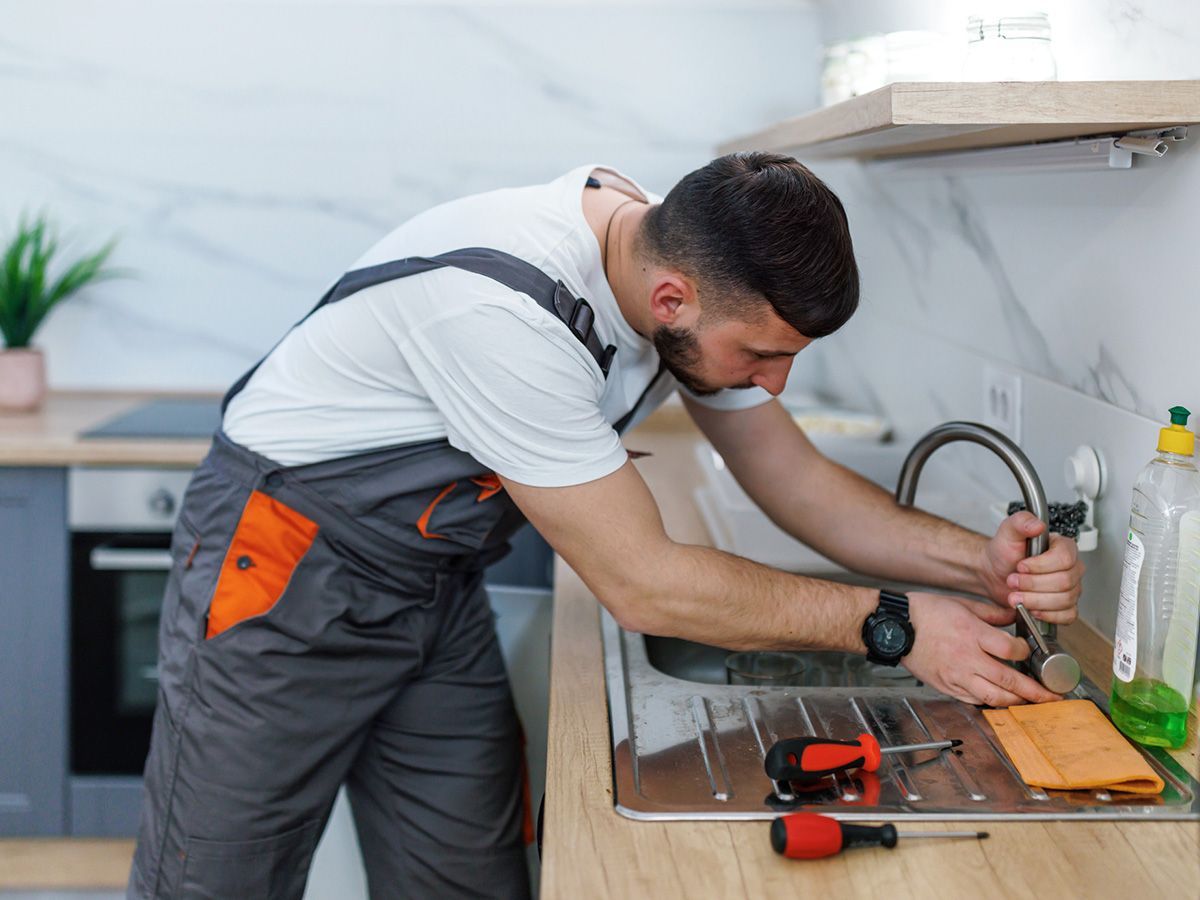 Plumber Fixing Faucet — Martinsville, VA — Handy Rentals, Inc. Plumber Fixing Faucet — Martinsville, VA — Handy Rentals, Inc.