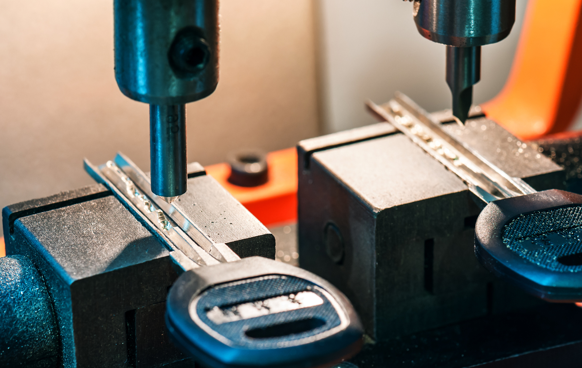 A close up of a key being cut on a machine.
