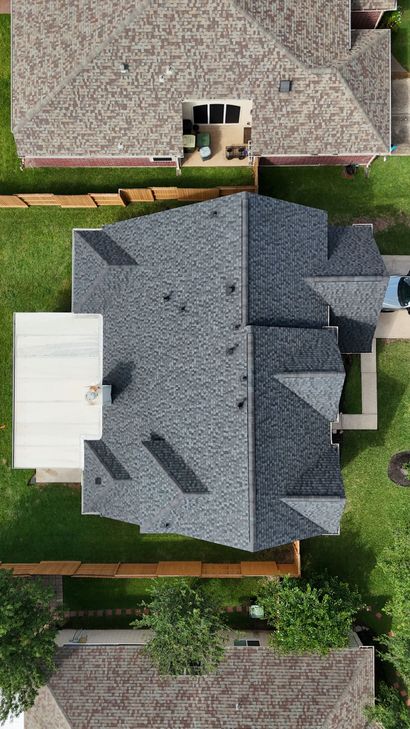 Roofer installing new shingles on a residential roof.