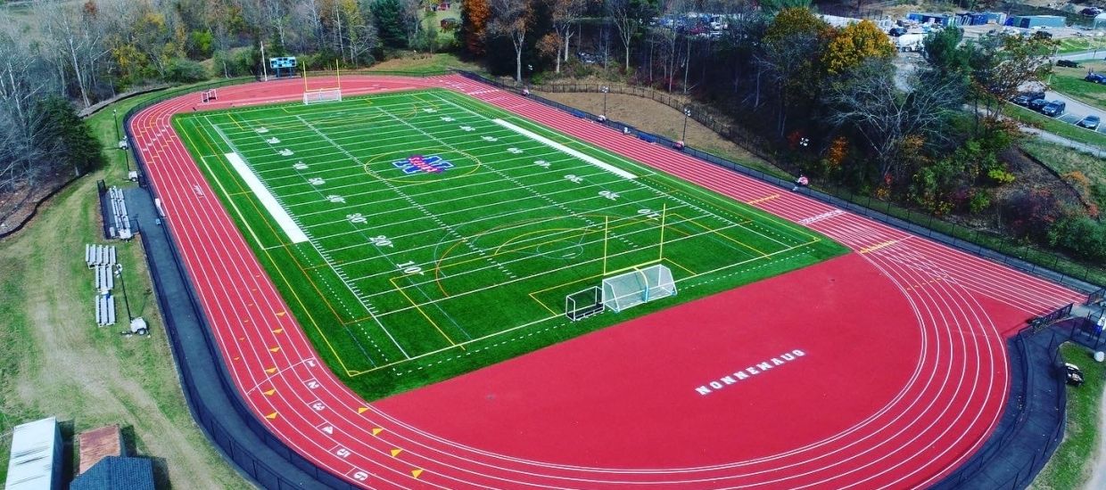 An aerial view of a football field with a running track.