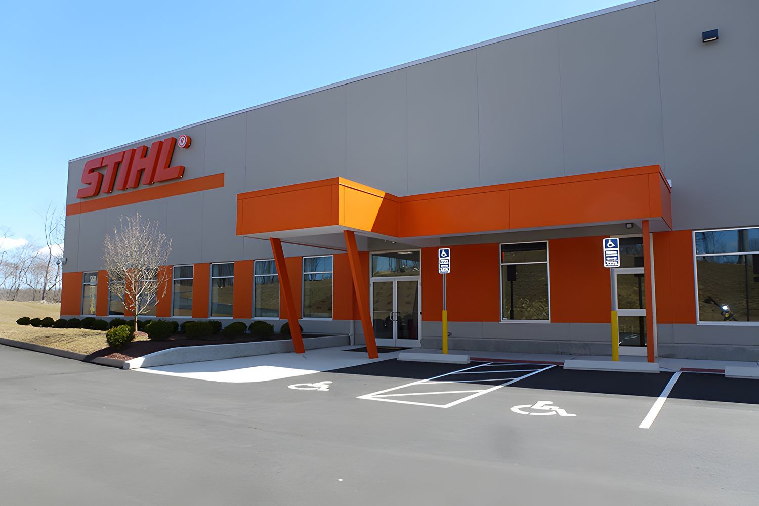 A Stihl building with a handicapped parking spot in front of it