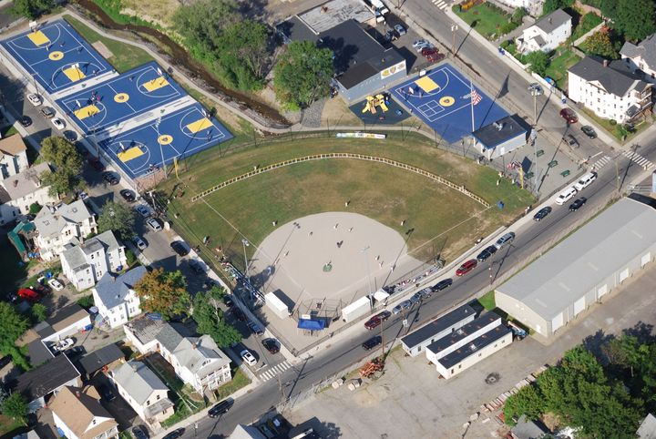 An aerial view of a baseball field and basketball courts