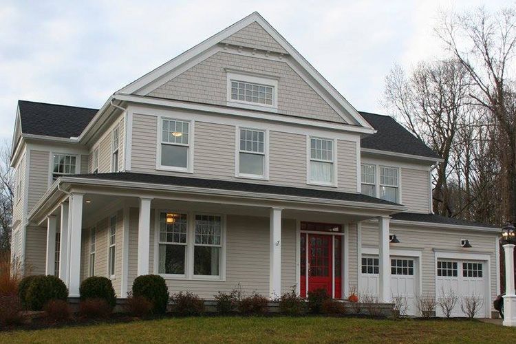 A large white house with a red door