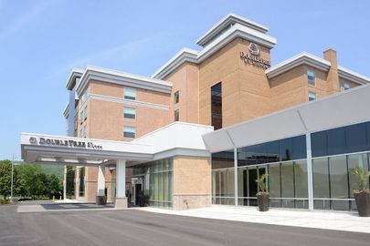 A large brick building with a white sign that says doubletree