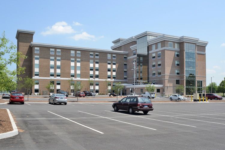 A large building with cars parked in front of it