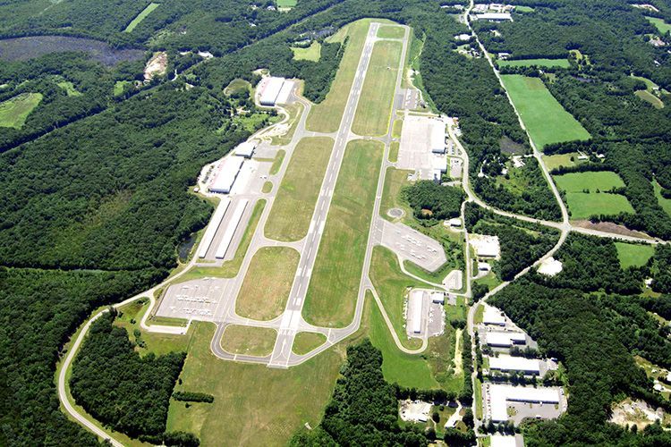 An aerial view of an airport surrounded by trees and grass