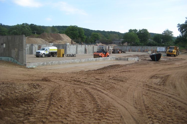 A construction site with a lot of dirt and trucks