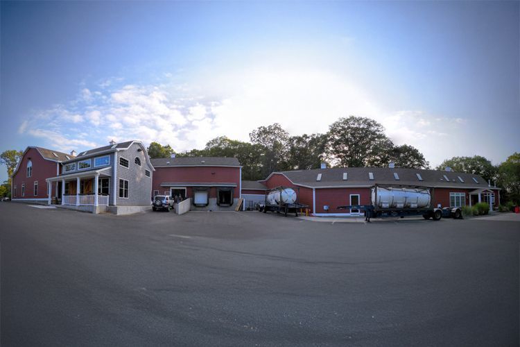 A large building with a lot of cars parked in front of it.