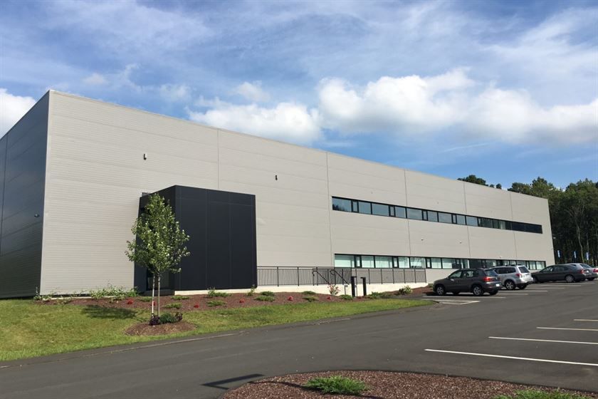 A large building with cars parked in front of it