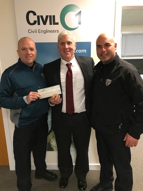 Three men standing in front of a wall that says civil engineers