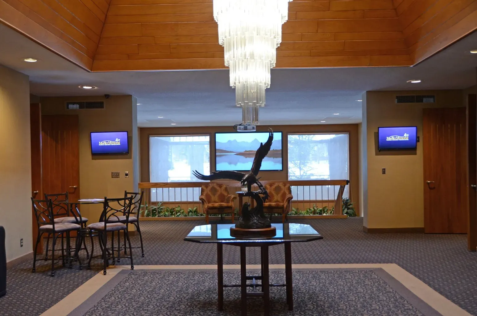 A statue of an eagle sits on a table in a lobby