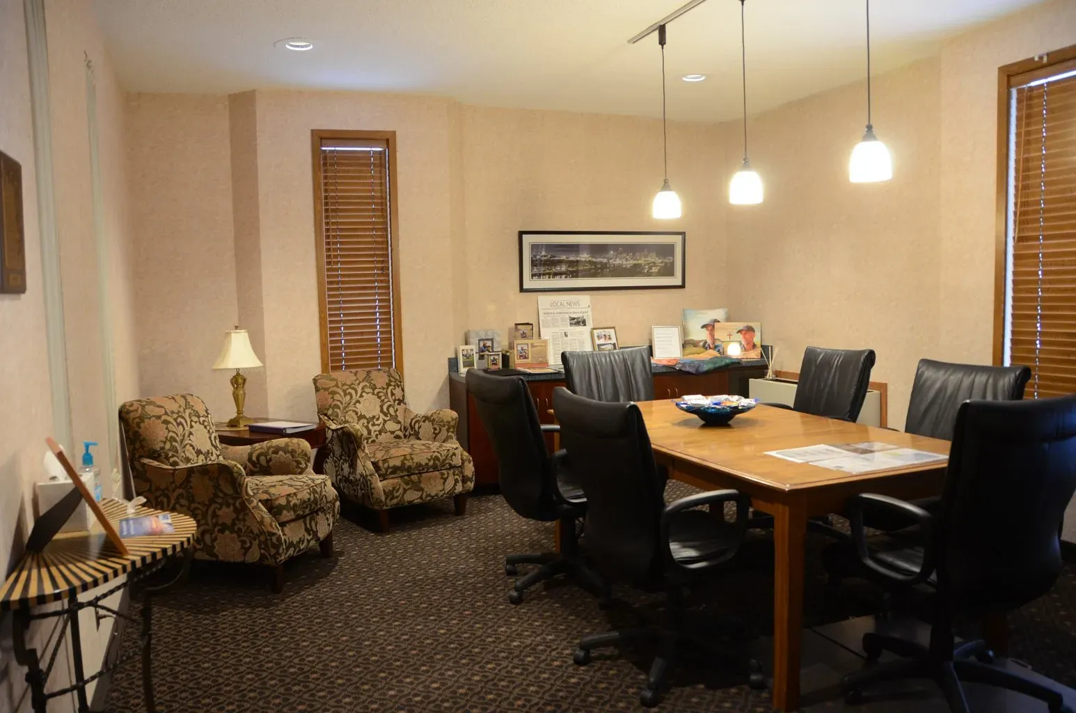 A conference room with a table and chairs in it