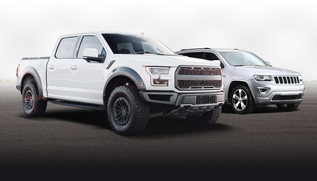 White pickup truck and silver SUV on a dark studio background, front angled view | Autoworx