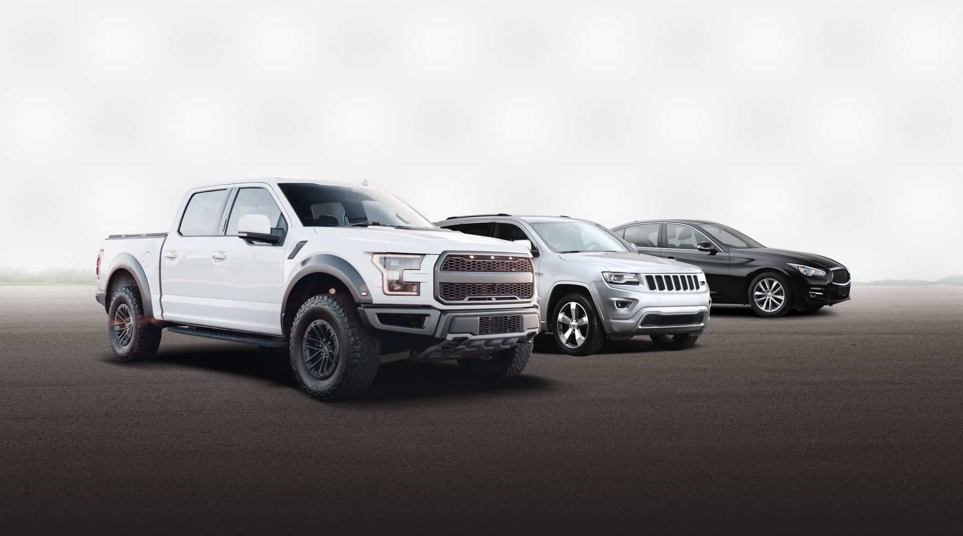 Three cars lined up on a road, led by a white pickup truck in front. | Autoworx