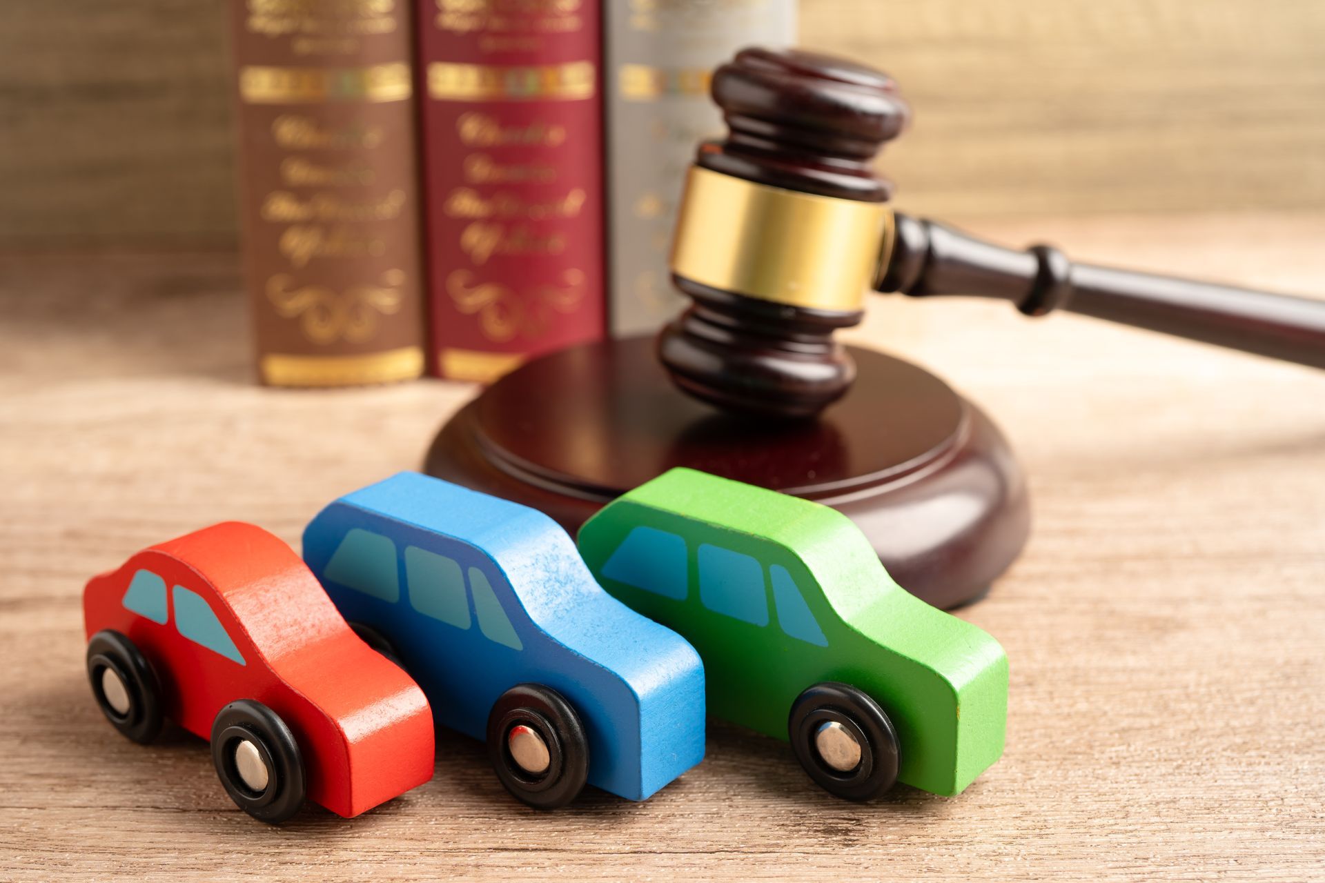 Car tire near a deep pothole filled with water on a damaged and uneven asphalt road. Auto accident attorney reviewing crash damage with an injured client after a car accident