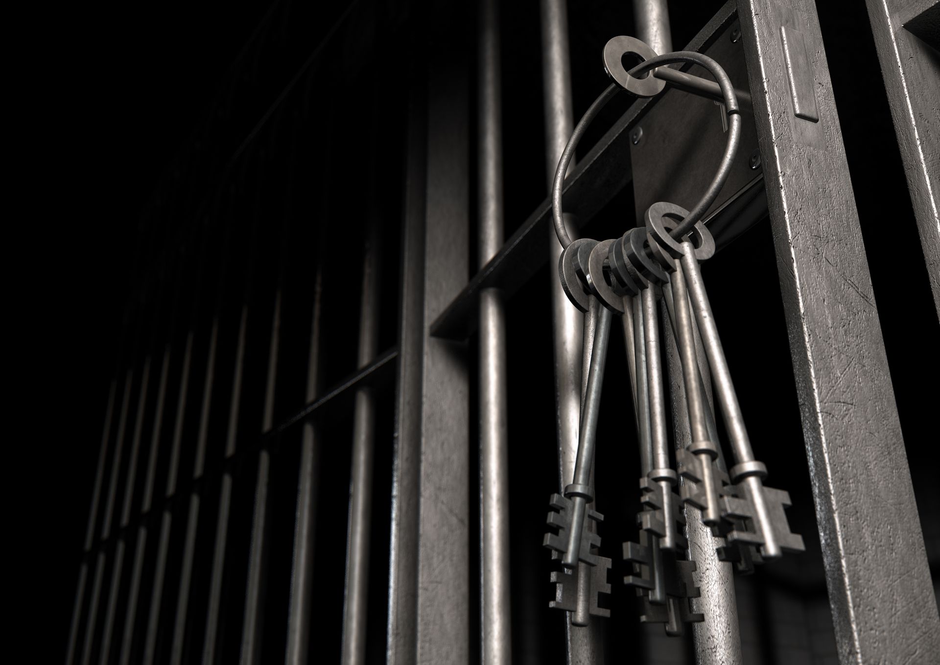 Keys hanging on a jail cell door.