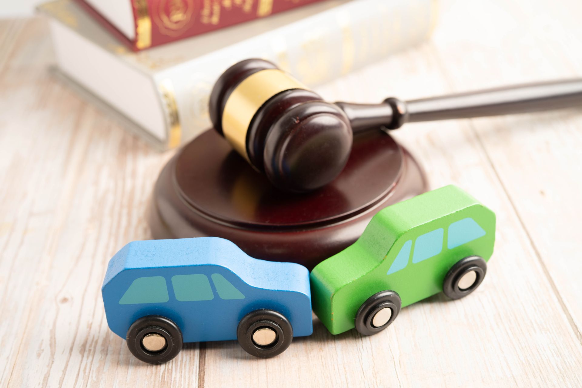 Judge hammer with car model, symbolizing a car accident lawsuit and insurance. Judge hammer with car model, symbolizing a car accident lawsuit and insurance.