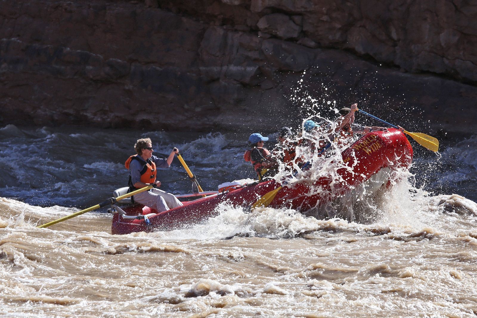 A group of people are rafting down a river